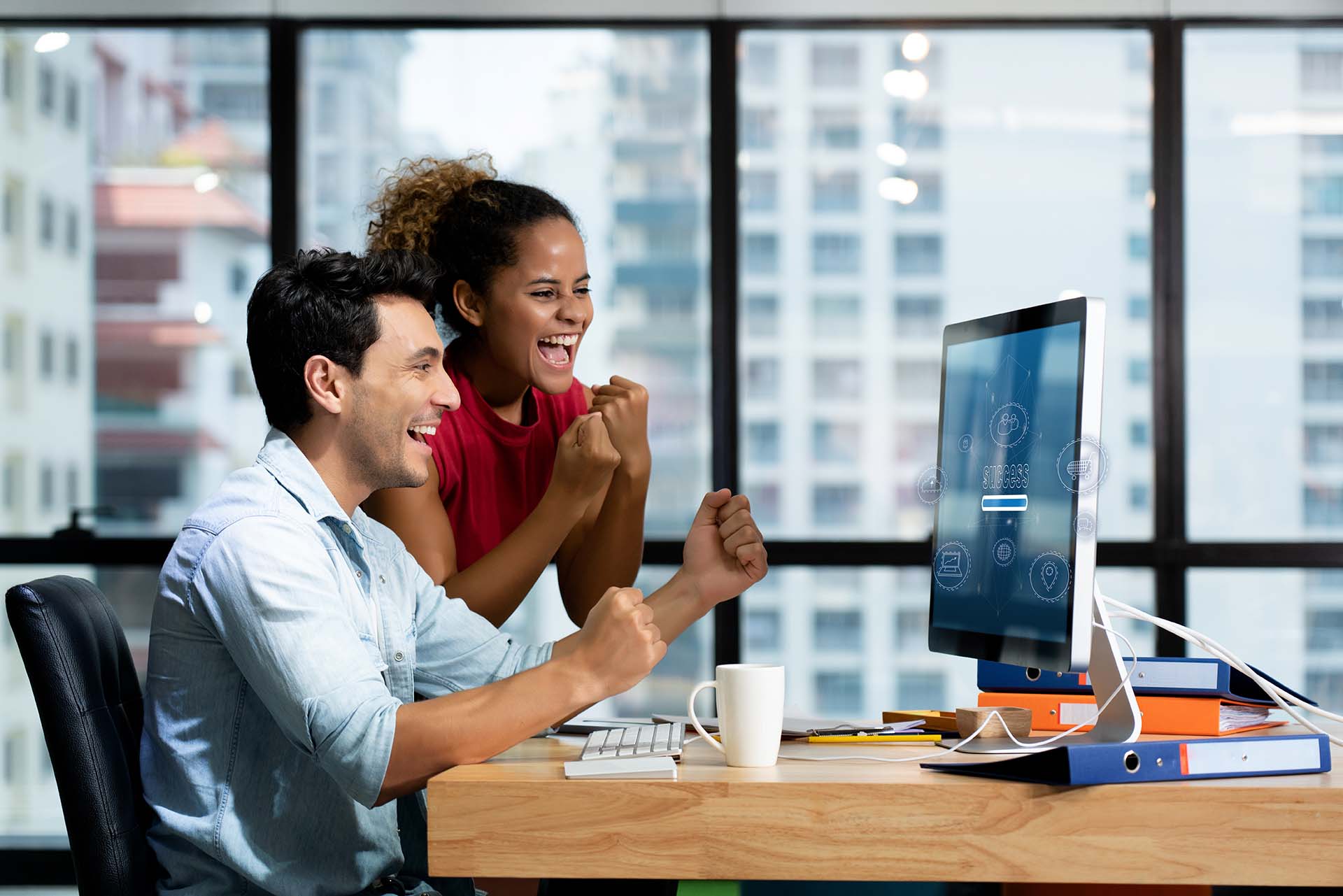 New generation businessmen feeling happy in front of computer in office. Since online sales system is able to work efficiently on a 5G network system. Causing sales to meet the target.