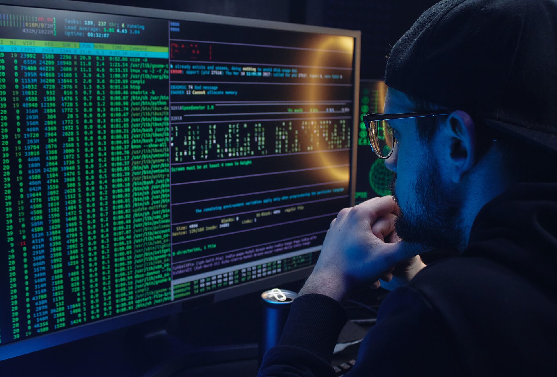 A man with glasses looking at the code