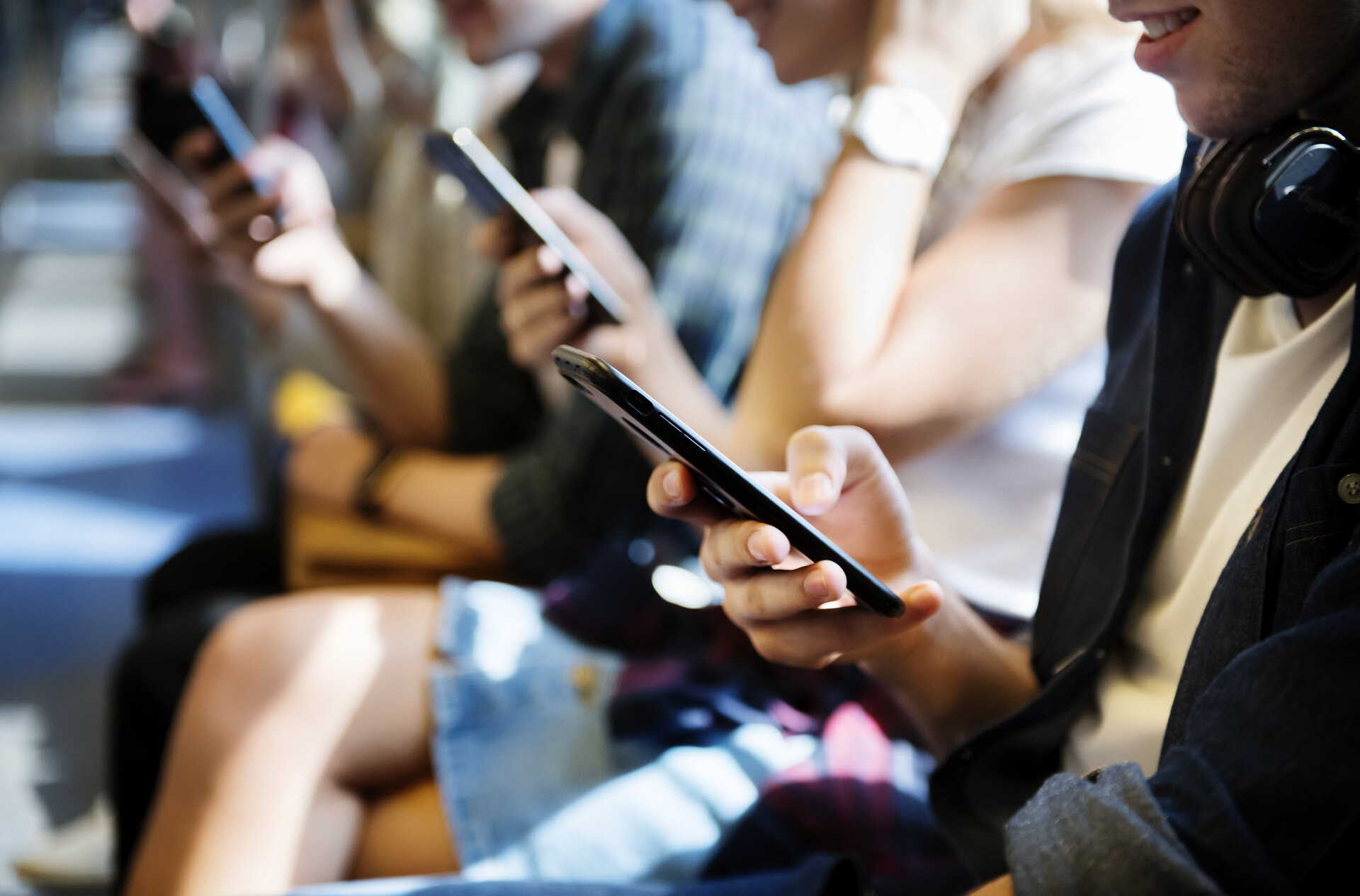 People in public transport using phones