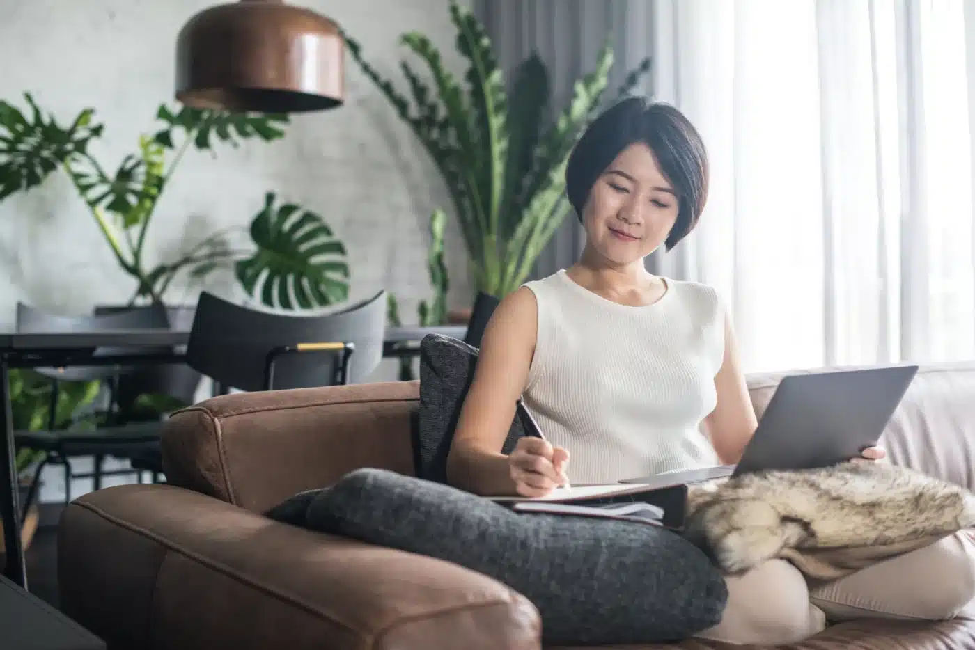 A woman working on a laptop at home