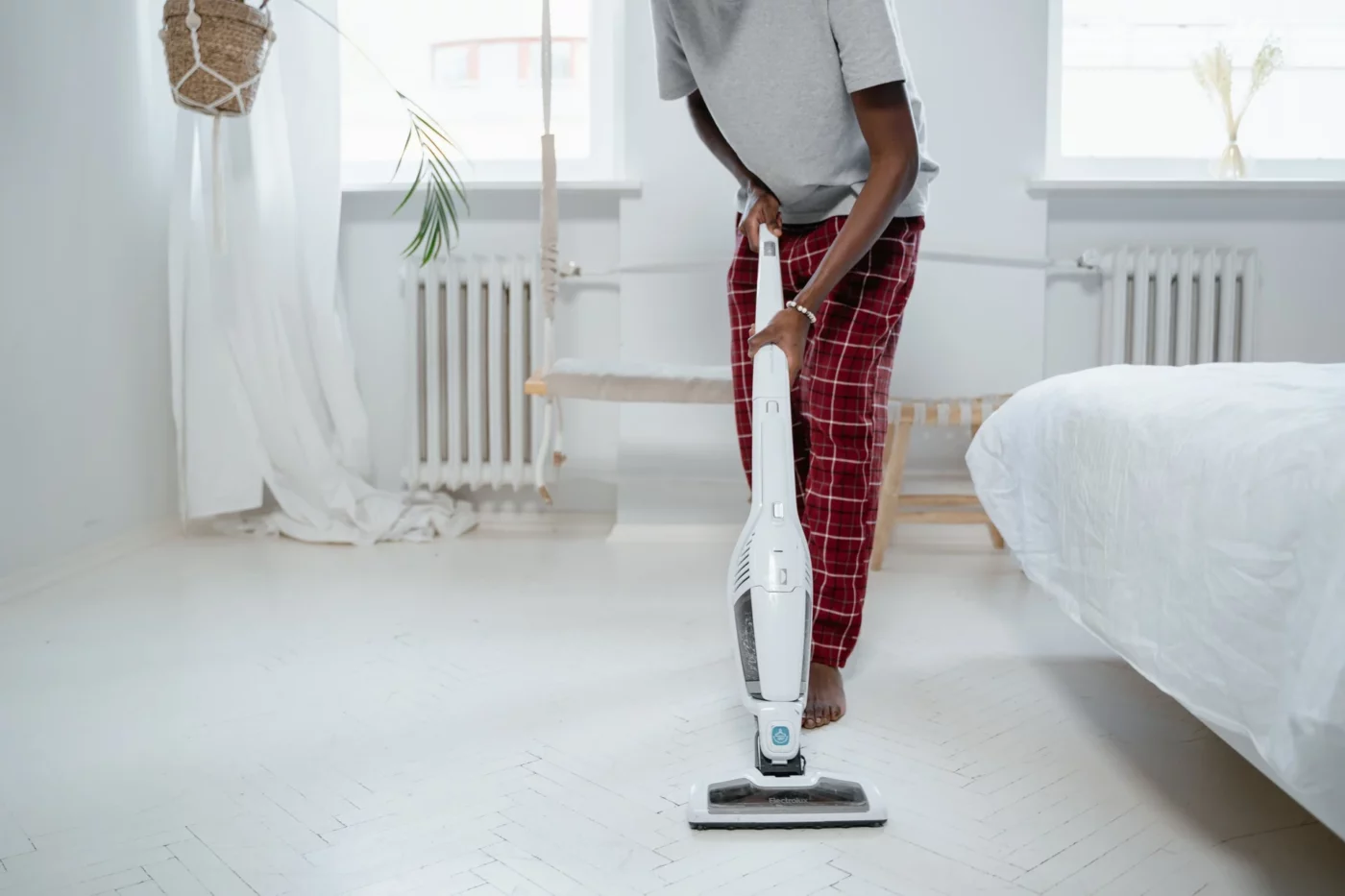 A woman using a bagless vacuum cleaner