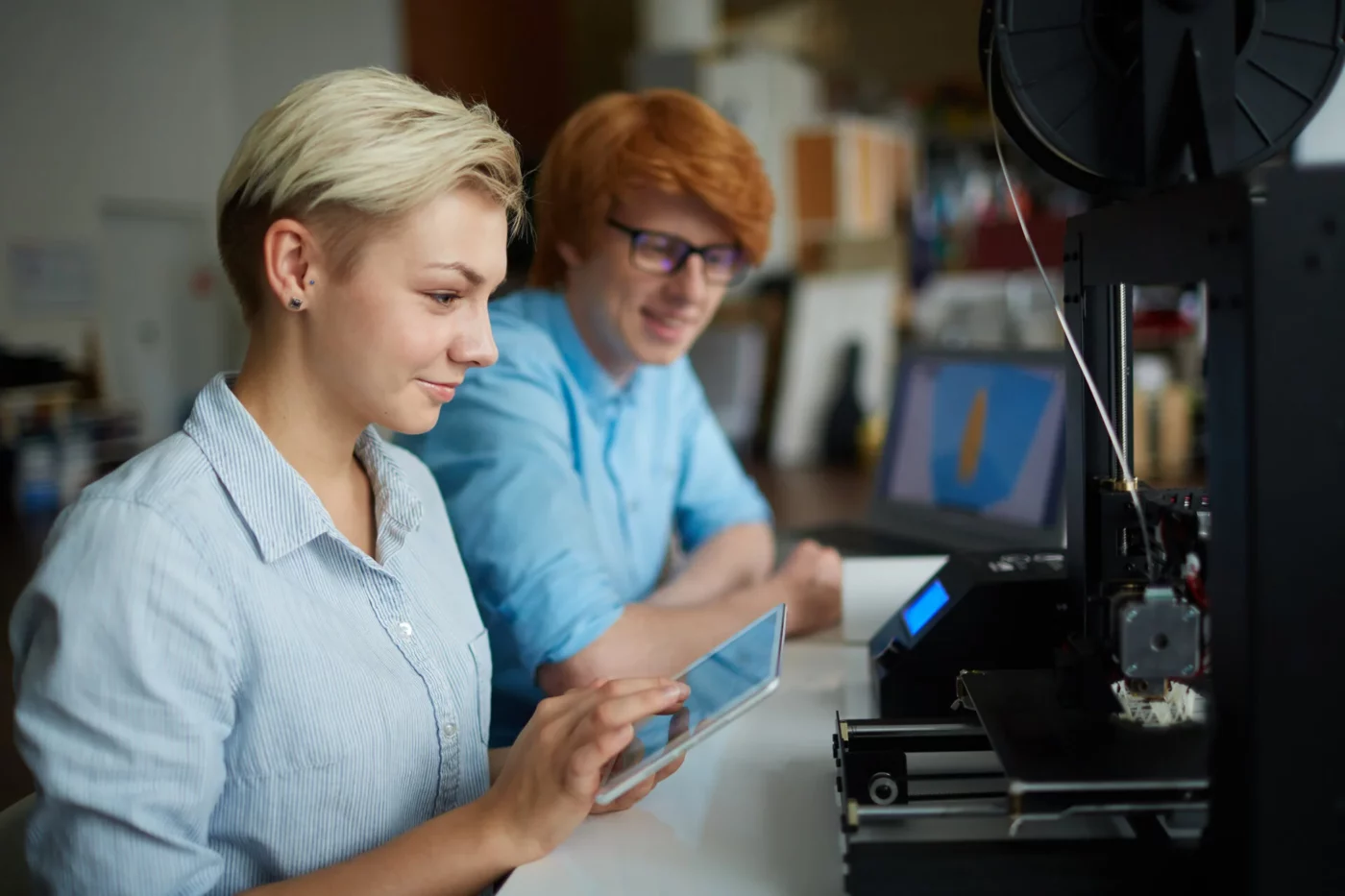 People working with a 3D printer