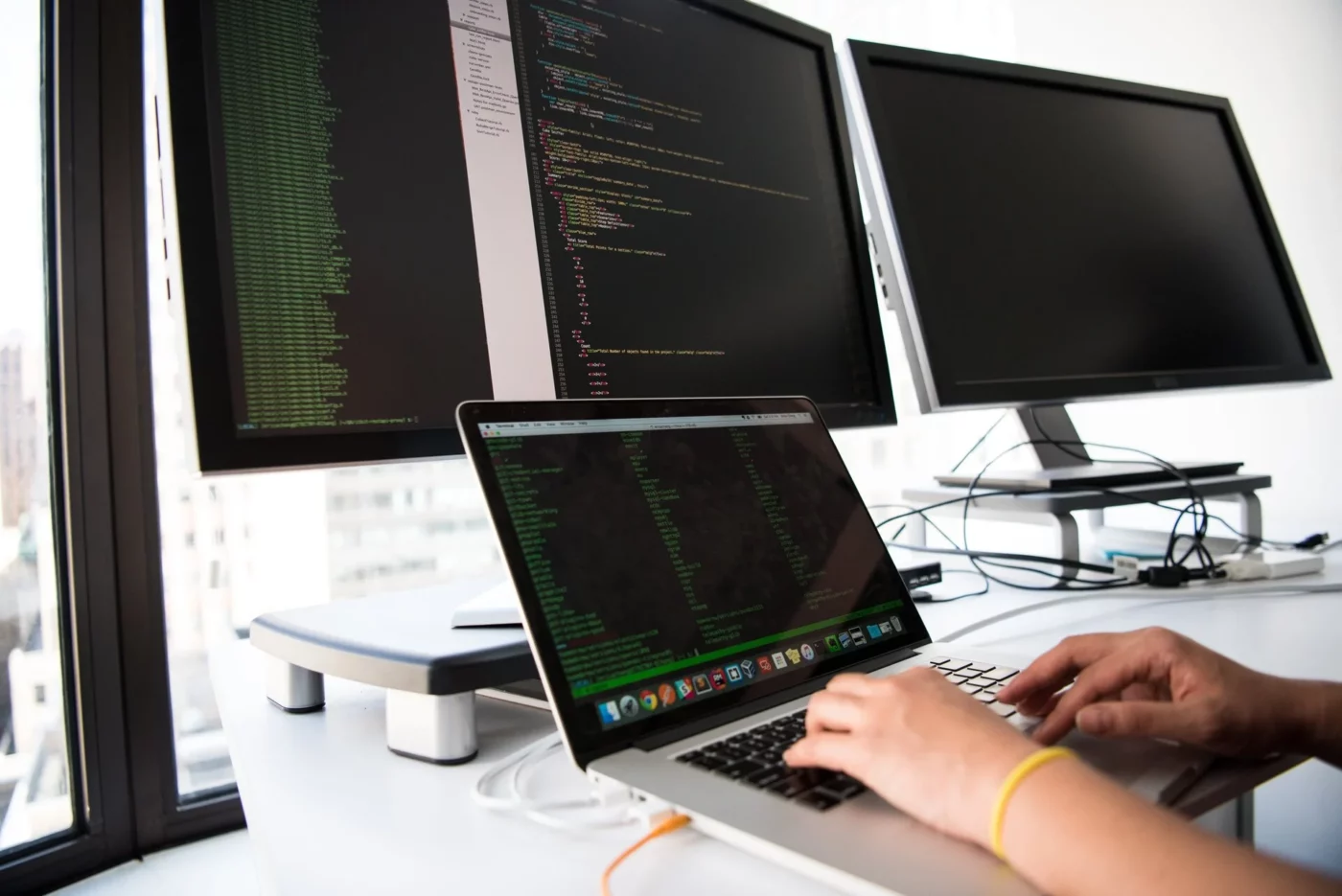 A woman programming on a laptop