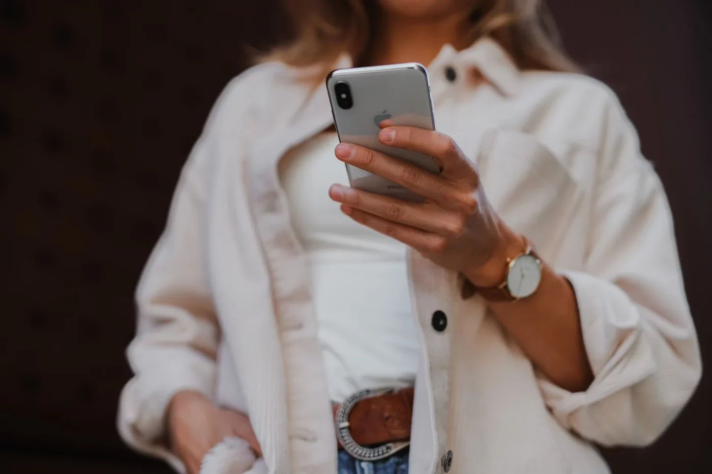 A woman looking at an iPhone