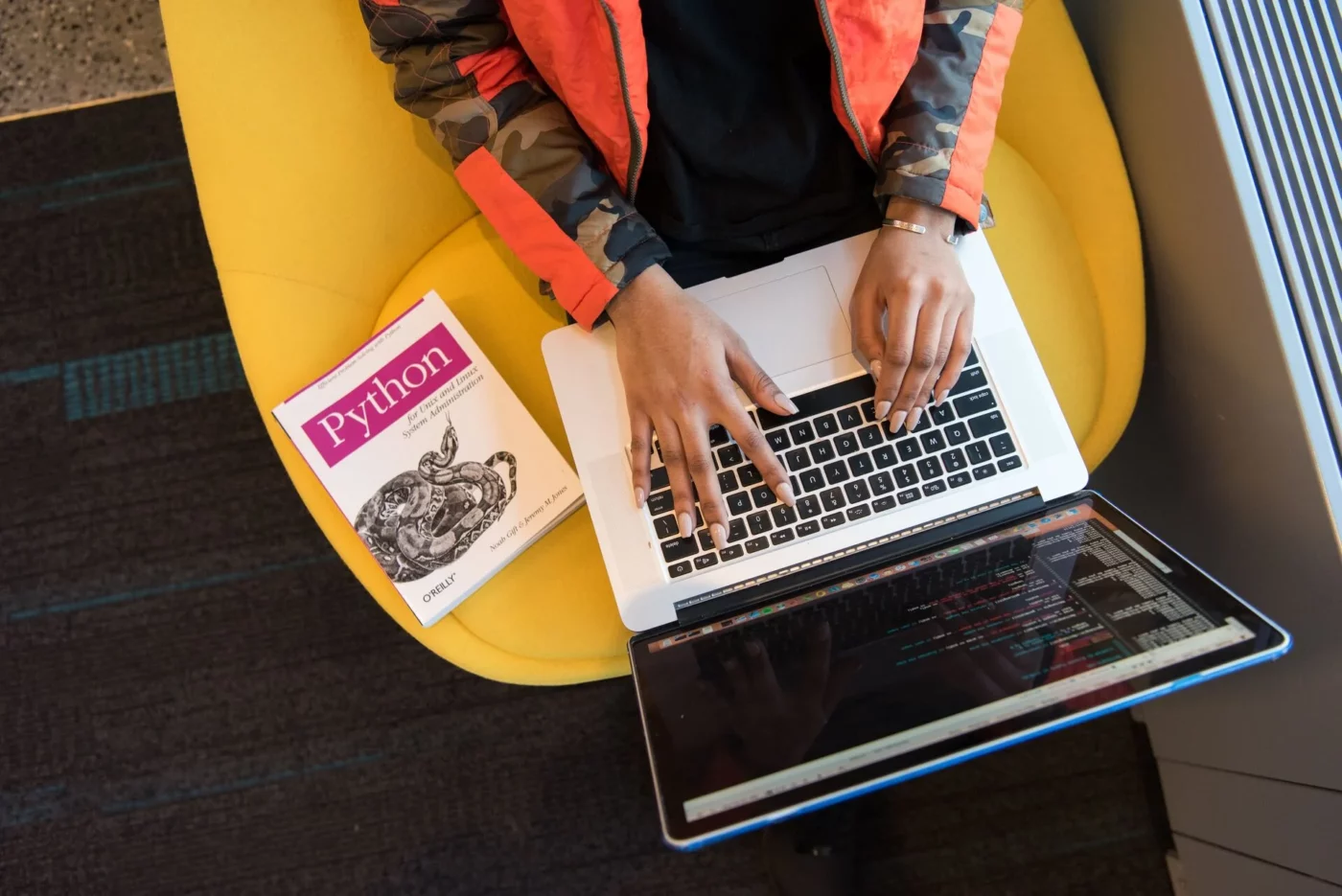 A woman programming using Python book