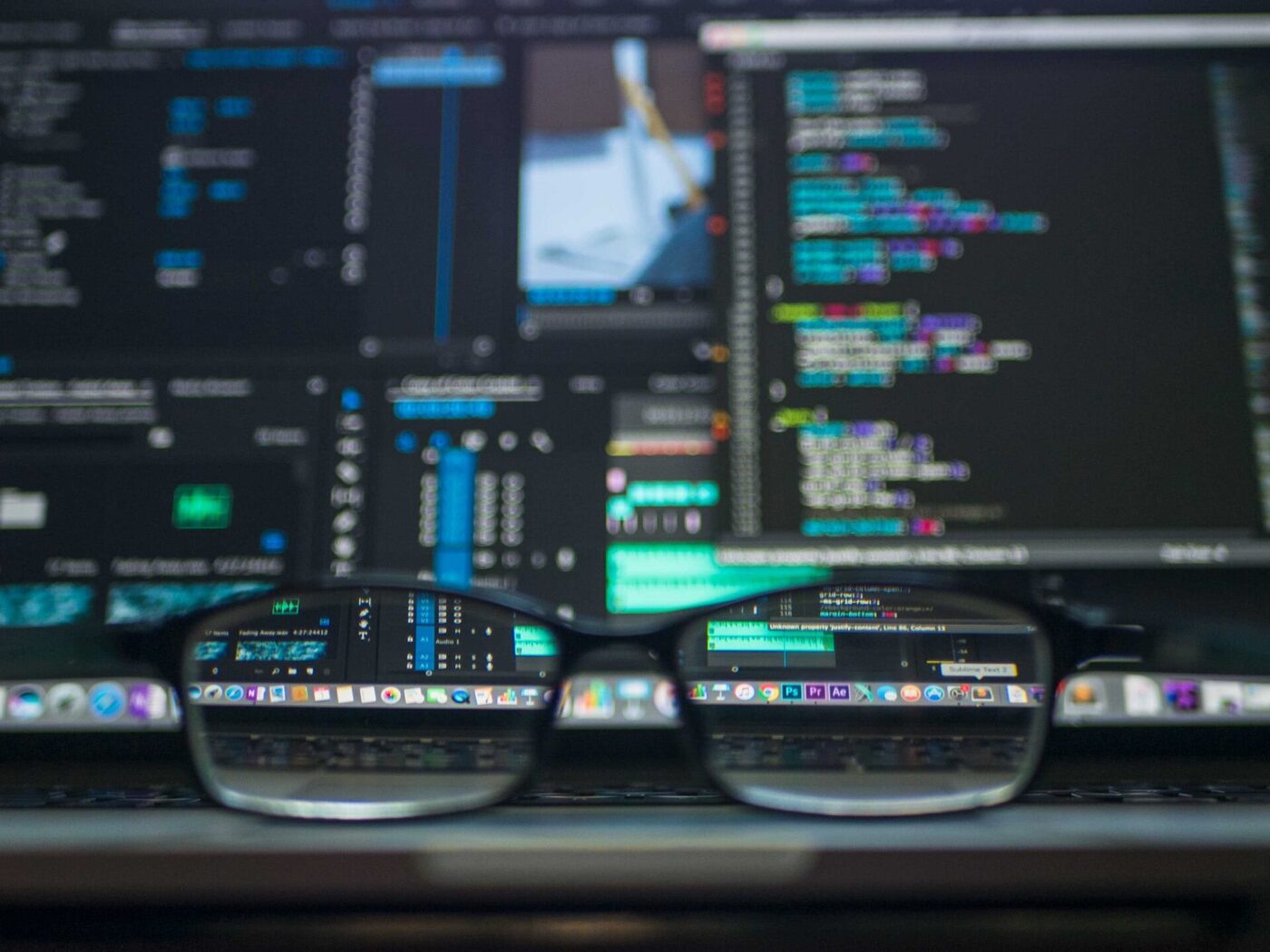 Glasses on the table overlooking a computer screen