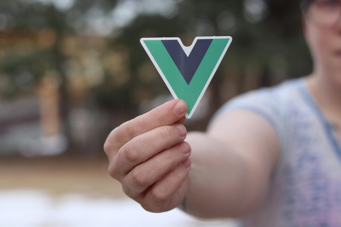 A person holding a Vue sticker