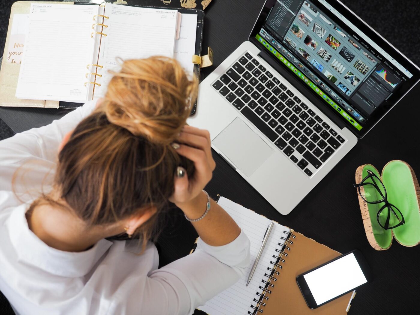 A woman stressing out in front of a laptop