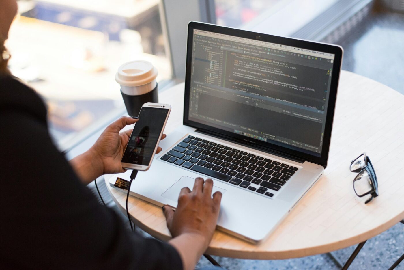 A developer holding a smartphone