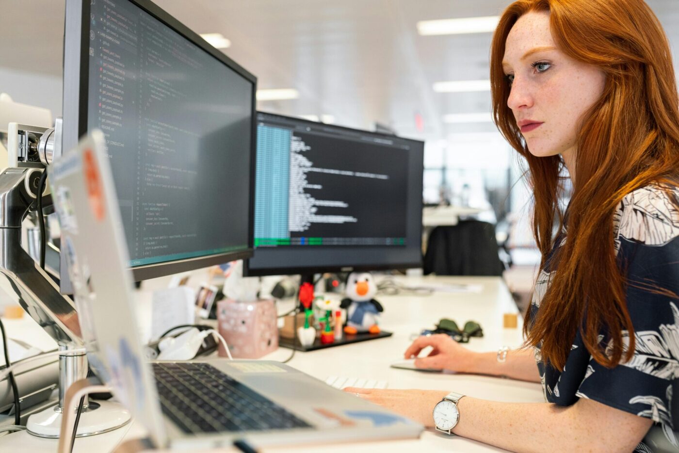 A woman coding on a computer