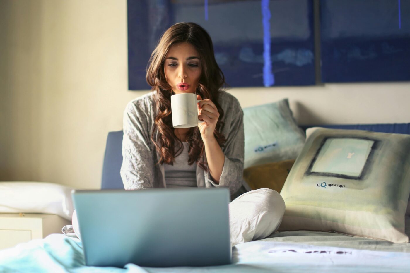 Woman drinking coffee while working